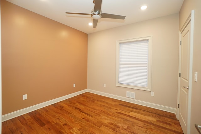 unfurnished room with ceiling fan and hardwood / wood-style flooring