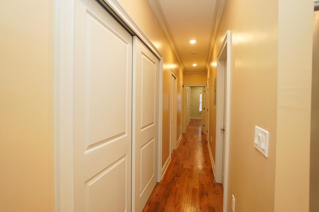 corridor with dark wood-type flooring and ornamental molding