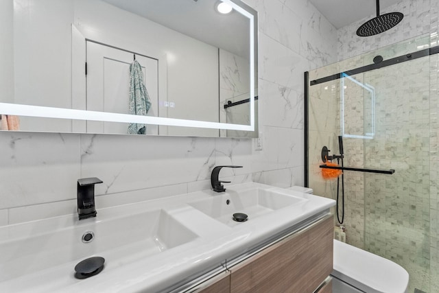 35 Manhattan Ave Unit 4, Jersey City, NJ 07307 - full bathroom featuring a shower stall, double vanity, and tasteful backsplash
