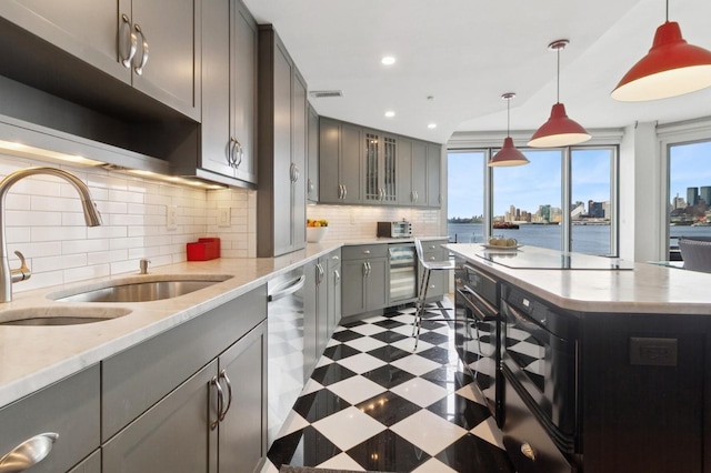 600 Harbor Blvd Unit 973/975, Weehawken, NJ 07086 - kitchen with gray cabinetry, tile patterned floors, black electric cooktop, stainless steel dishwasher, and plenty of natural light