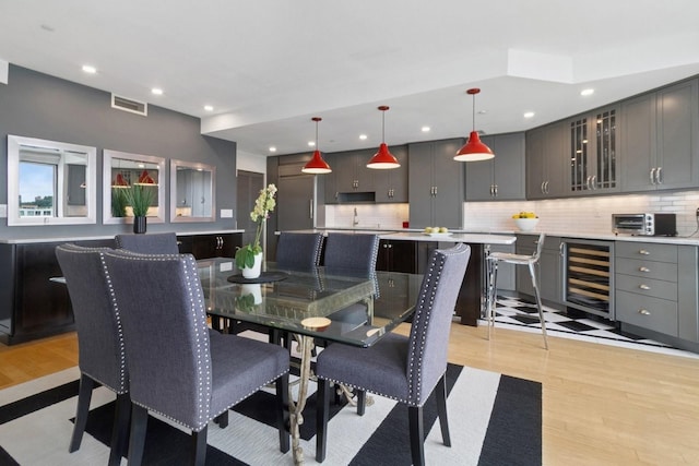 600 Harbor Blvd Unit 973/975, Weehawken, NJ 07086 - dining room with beverage cooler, light wood-style floors, recessed lighting, and bar area