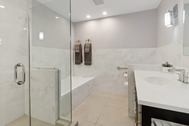 600 Harbor Blvd Unit 973/975, Weehawken, NJ 07086 - full bathroom featuring vanity, a garden tub, a marble finish shower, tile walls, and tile patterned floors