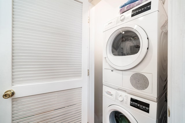 washroom featuring laundry area and stacked washer and dryer
