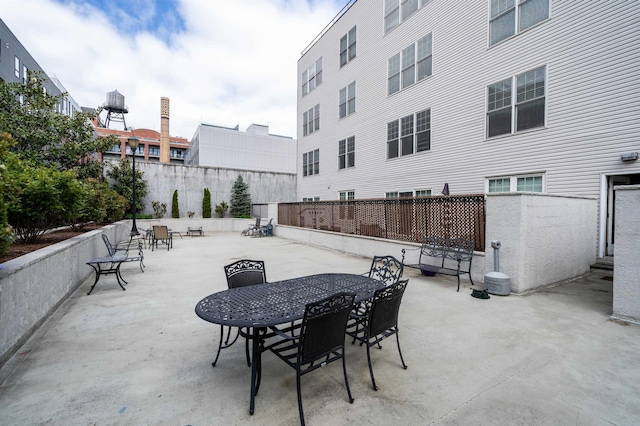 view of patio featuring fence and outdoor dining space
