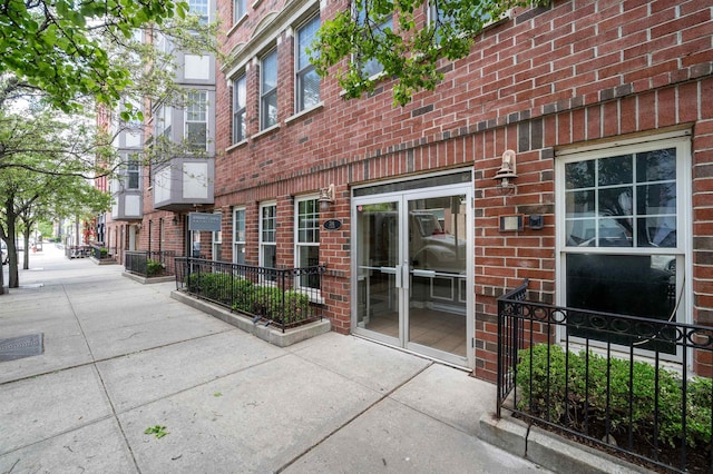 property entrance featuring a residential view and brick siding