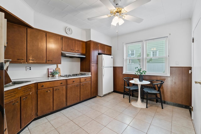 388 Kennedy Blvd, Bayonne, NJ 07002 - kitchen featuring freestanding refrigerator, under cabinet range hood, ceiling fan, light countertops, and wainscoting