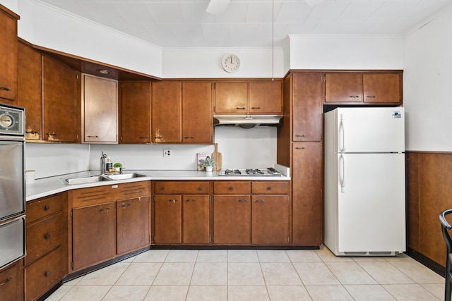 388 Kennedy Blvd, Bayonne, NJ 07002 - kitchen featuring freestanding refrigerator, crown molding, light countertops, under cabinet range hood, and a warming drawer