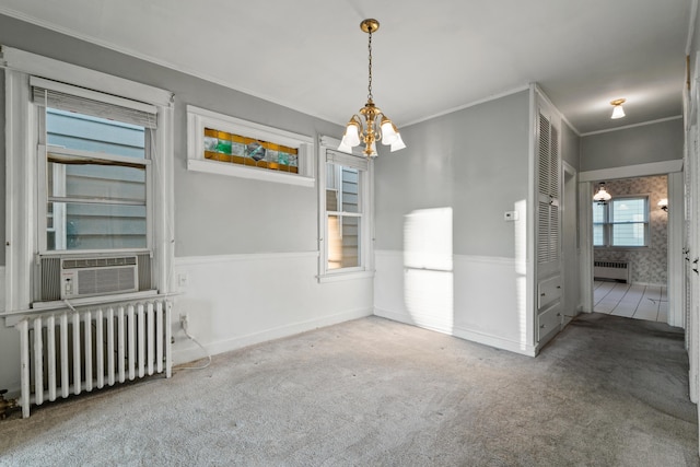 388 Kennedy Blvd, Bayonne, NJ 07002 - unfurnished dining area with radiator heating unit, a chandelier, radiator, ornamental molding, and carpet floors