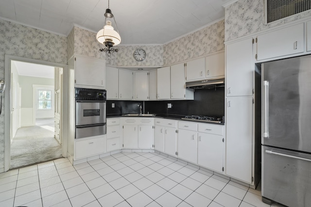 388 Kennedy Blvd, Bayonne, NJ 07002 - kitchen with appliances with stainless steel finishes, wallpapered walls, crown molding, dark countertops, and a warming drawer