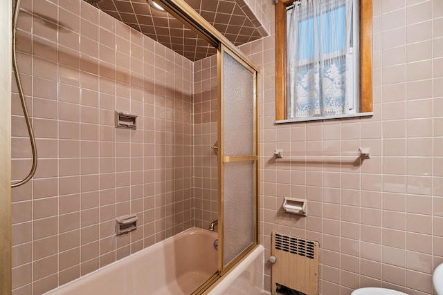 388 Kennedy Blvd, Bayonne, NJ 07002 - full bathroom with radiator heating unit, shower / bath combination with glass door, and tile walls