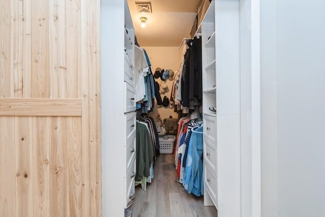 spacious closet featuring light wood-style flooring