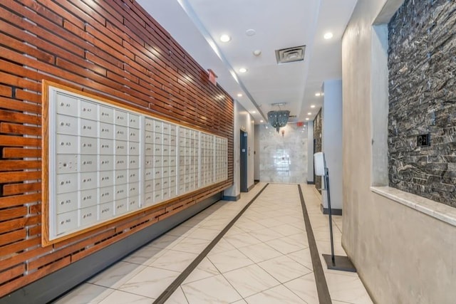 corridor with recessed lighting, visible vents, and marble finish floor