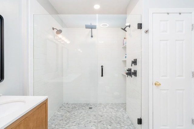 full bath featuring vanity and a shower stall