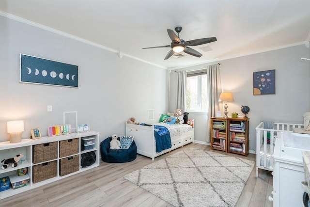 bedroom with ceiling fan, wood finished floors, and ornamental molding