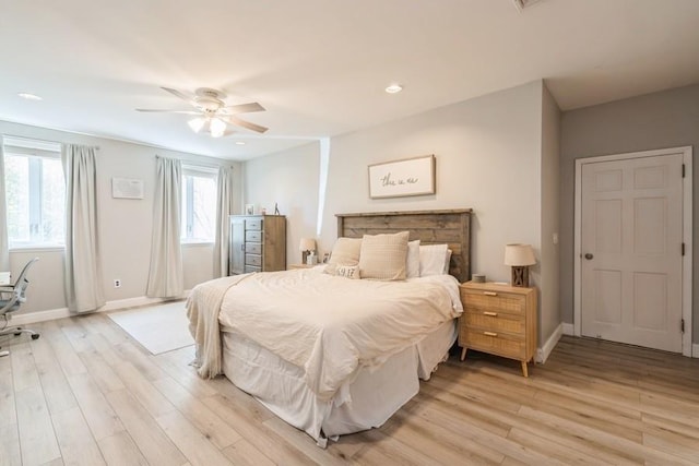 bedroom with baseboards, light wood finished floors, and ceiling fan