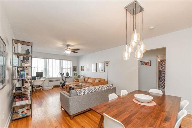 2520 Kennedy Blvd Unit 1H, Jersey City, NJ 07304 - dining space featuring radiator heating unit, light wood-style flooring, a ceiling fan, an office area, and baseboards