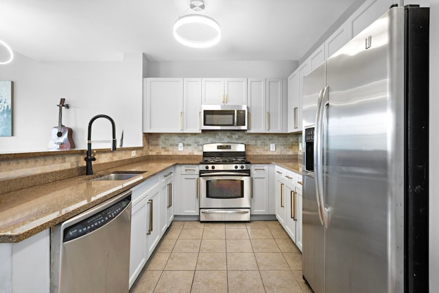 15 Freedom Way Unit 401, Jersey City, NJ 07305 - kitchen with appliances with stainless steel finishes, backsplash, white cabinetry, and light tile patterned flooring