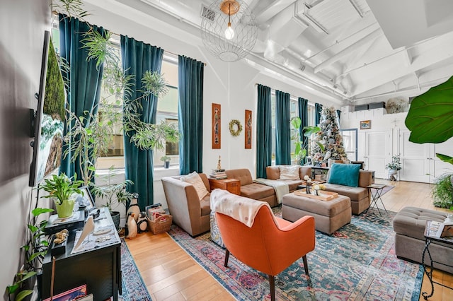 sunroom / solarium featuring beam ceiling and visible vents