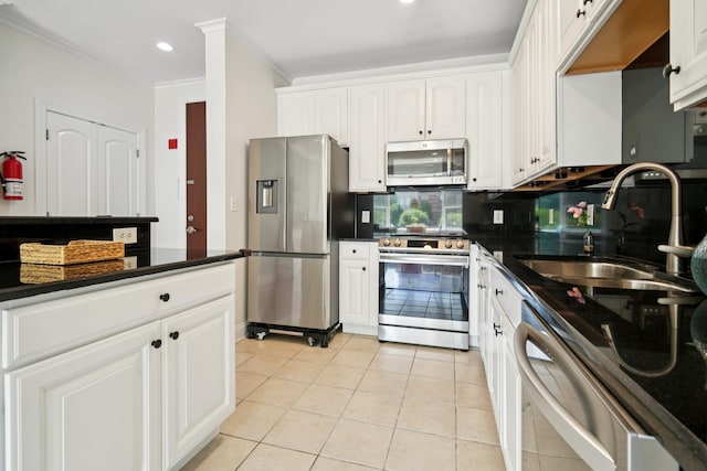 22 Ave At Port Imperial Unit 227, West New York, NJ 07093 - kitchen featuring stainless steel appliances, dark countertops, ornamental molding, white cabinets, and light tile patterned floors