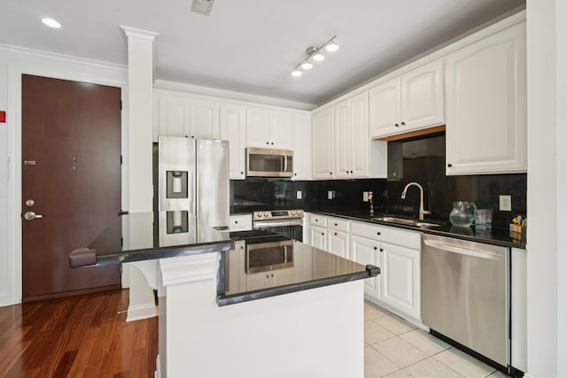 22 Ave At Port Imperial Unit 227, West New York, NJ 07093 - kitchen featuring stainless steel appliances, dark countertops, white cabinetry, tasteful backsplash, and crown molding