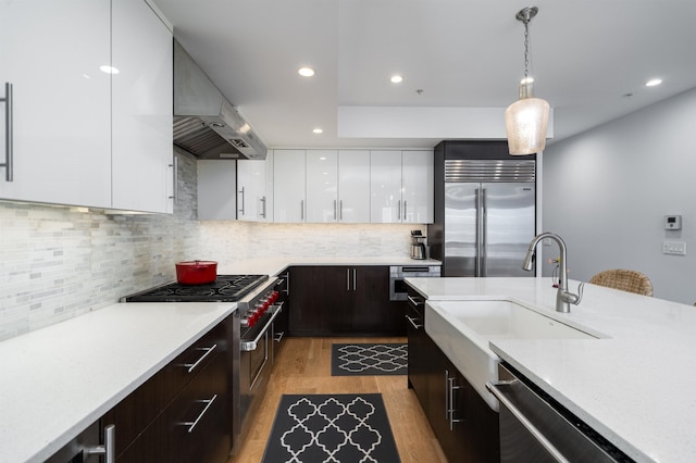 74 Madison St Unit 2, Hoboken, NJ 07030 - kitchen with premium appliances, modern cabinets, exhaust hood, light countertops, and recessed lighting