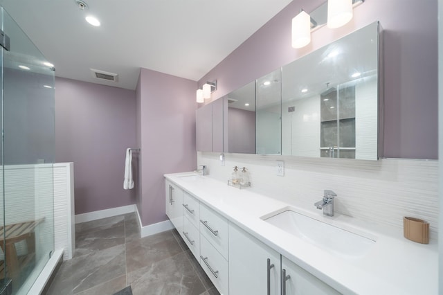 74 Madison St Unit 2, Hoboken, NJ 07030 - bathroom featuring tasteful backsplash, baseboards, double vanity, recessed lighting, and a shower with door