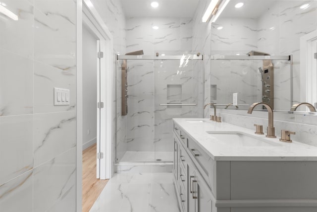 119 Van Horne St Unit 1, Jersey City, NJ 07304 - full bath with double vanity, a marble finish shower, marble finish flooring, and recessed lighting