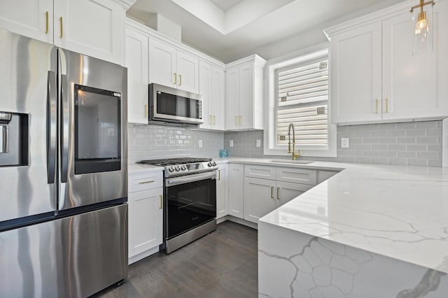 119 Van Horne St Unit 1, Jersey City, NJ 07304 - kitchen with stainless steel appliances, dark wood finished floors, white cabinetry, light stone countertops, and backsplash