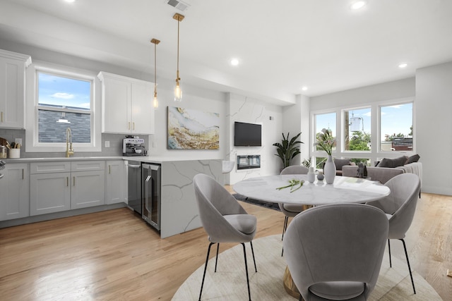 119 Van Horne St Unit 1, Jersey City, NJ 07304 - dining space featuring healthy amount of natural light, light wood finished floors, recessed lighting, and beverage cooler