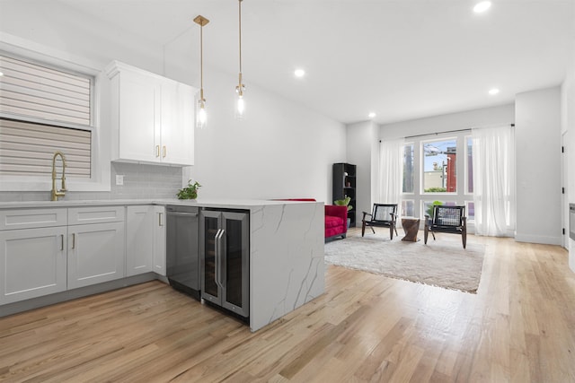 119 Van Horne St Unit 1, Jersey City, NJ 07304 - kitchen featuring light wood-style flooring, beverage cooler, a peninsula, decorative backsplash, and recessed lighting
