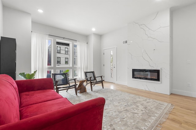 119 Van Horne St Unit 1, Jersey City, NJ 07304 - living room with a high end fireplace, wood finished floors, and recessed lighting