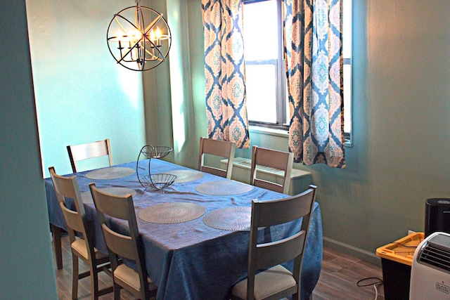 dining room featuring dark hardwood / wood-style floors and a chandelier