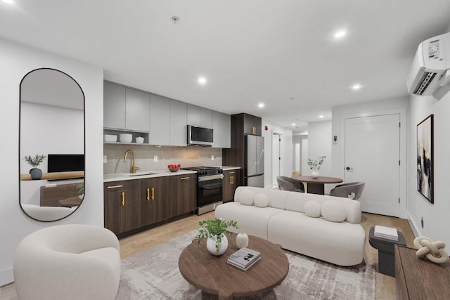 living room featuring light wood-type flooring, an AC wall unit, and recessed lighting