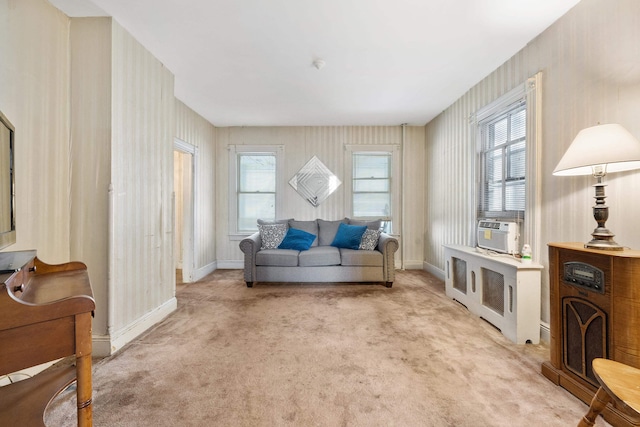 living area with light colored carpet, cooling unit, and a wealth of natural light