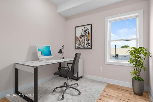 home office with baseboards and wood finished floors