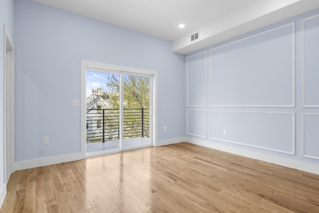 empty room featuring baseboards, recessed lighting, light wood-style flooring, and visible vents