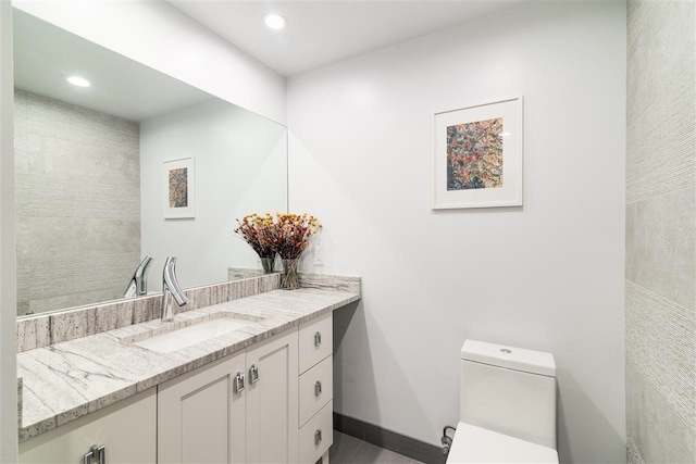 bathroom with toilet and vanity