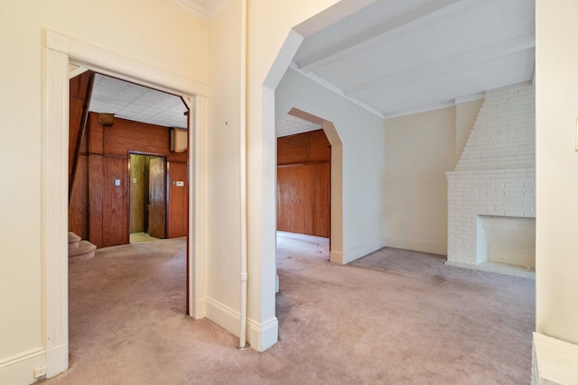 hall featuring arched walkways, stairway, crown molding, and carpet floors