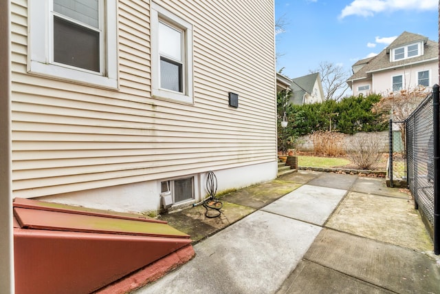 view of side of property with a patio area and fence