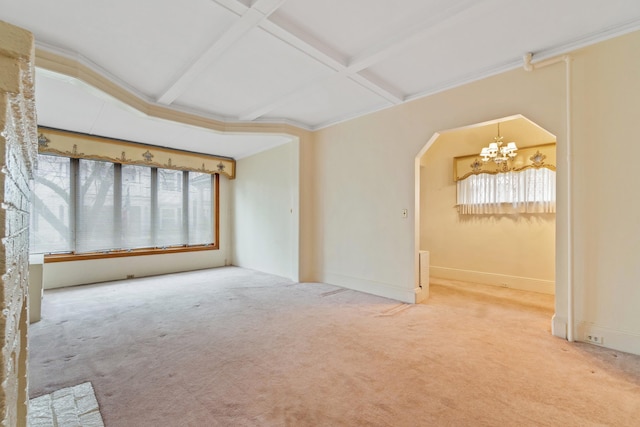 carpeted empty room featuring arched walkways, a chandelier, beamed ceiling, and coffered ceiling