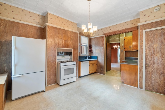 kitchen with wallpapered walls, light floors, brown cabinets, an inviting chandelier, and white appliances