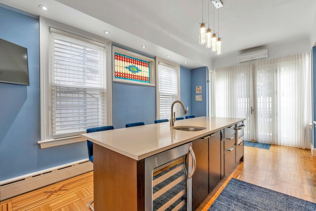 7 Clifton Ter, Weehawken, NJ 07086 - kitchen featuring wine cooler, a sink, baseboard heating, a wall unit AC, and an island with sink
