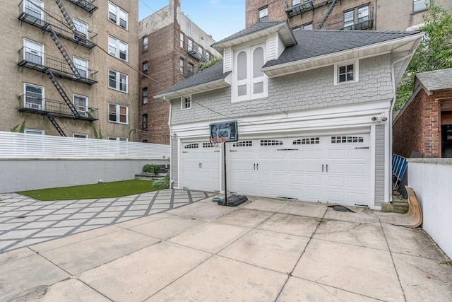 7 Clifton Ter, Weehawken, NJ 07086 - rear view of house featuring a shingled roof, a garage, and concrete driveway