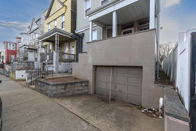 view of front of home featuring a garage and a balcony