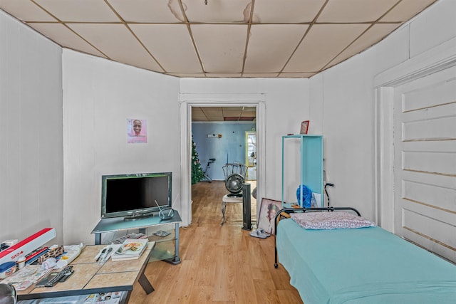 bedroom featuring a paneled ceiling and light wood-type flooring