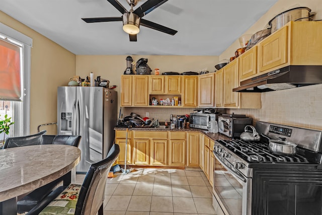 kitchen featuring ceiling fan, decorative backsplash, light brown cabinetry, appliances with stainless steel finishes, and light tile patterned flooring