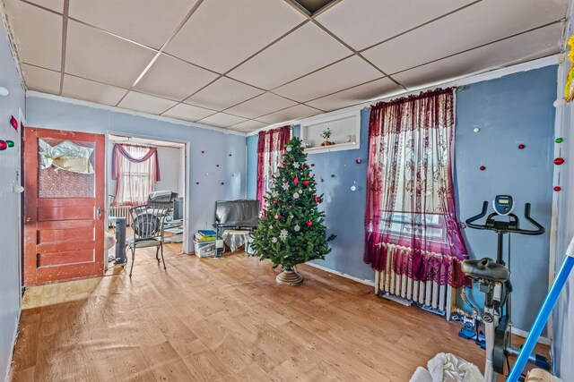 misc room featuring hardwood / wood-style floors and a paneled ceiling