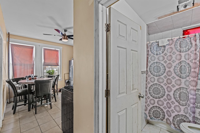 interior space with tile patterned floors and ceiling fan