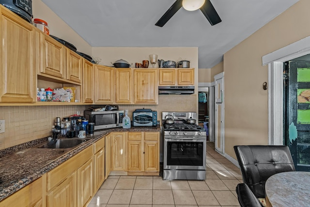 kitchen featuring sink, light brown cabinetry, light tile patterned flooring, and appliances with stainless steel finishes