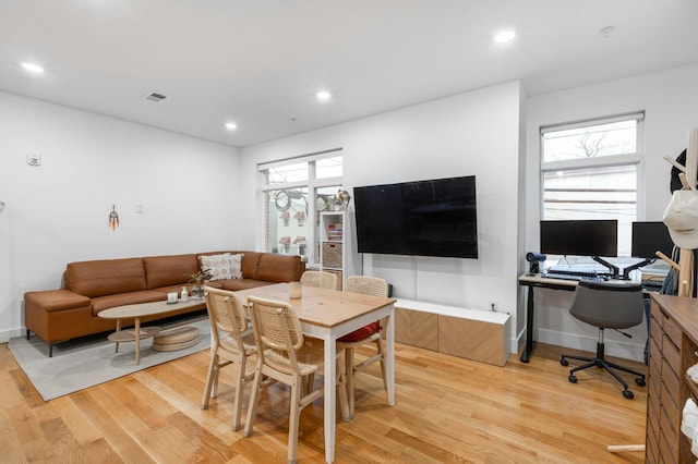 dining space with a wealth of natural light and light wood-type flooring